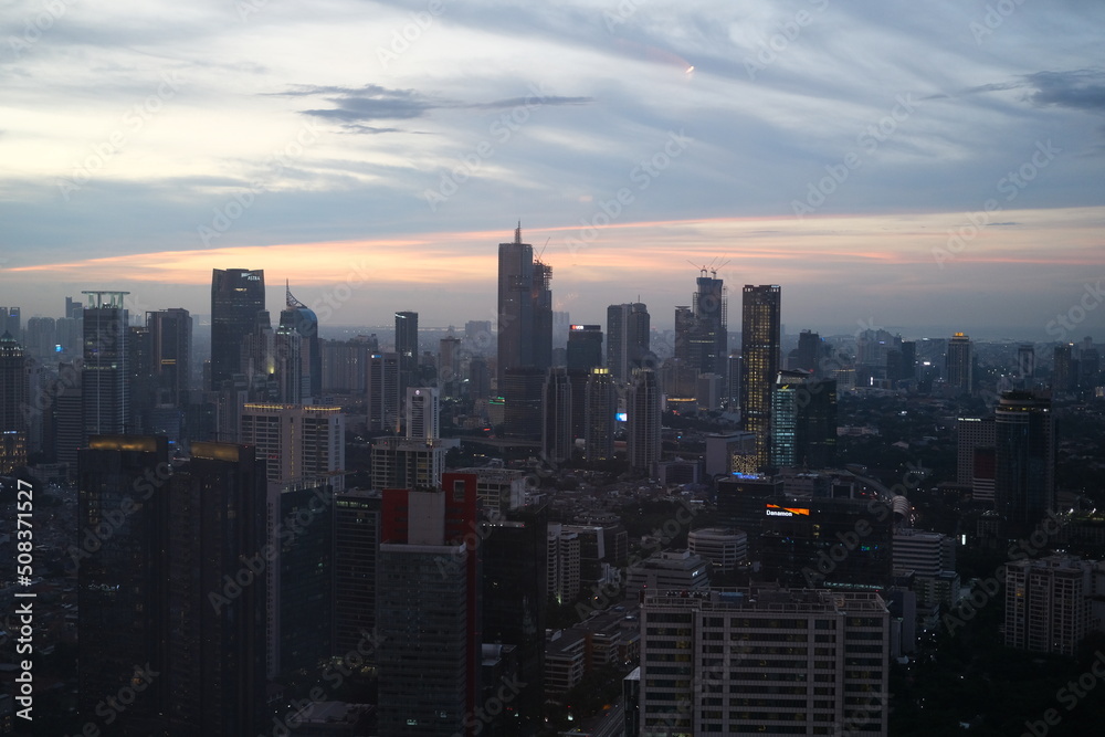 Jakarta city viewed from the top and at sunset