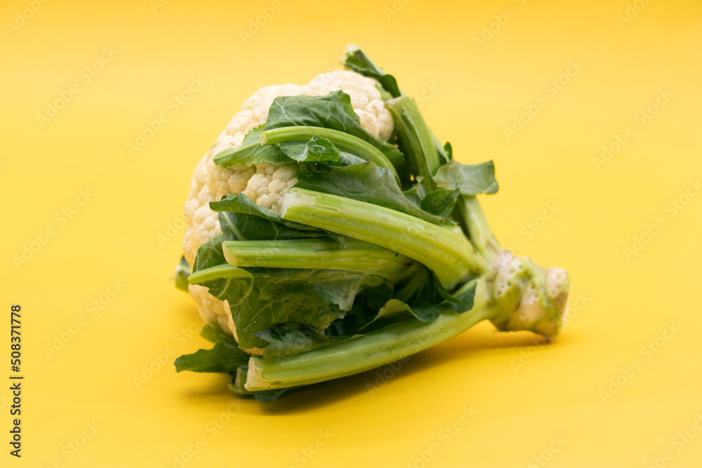 Cauliflower without leaves isolated on yellow background Cauliflower without leaves isolated on yellow background