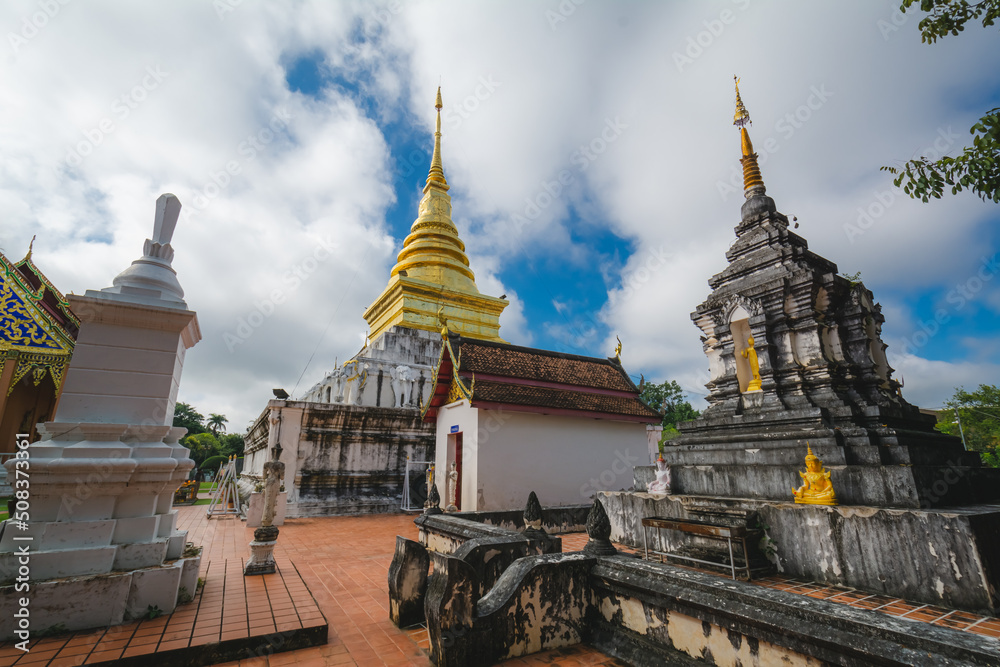 Fototapeta premium The golden stupa at Wat Phra That Chang Kham Worawihan, or Phrathat Chang Kham Worawihan temple, is the one attraction and is famous in Nan province, Thailand.