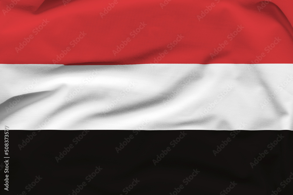 Yemen national flag, folds and hard shadows on the canvas
