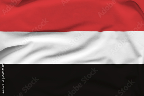 Yemen national flag, folds and hard shadows on the canvas