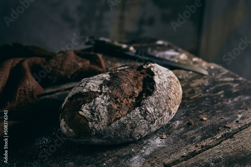 Delicious fresh bread on table in kitchen