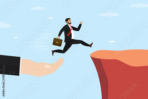 Hand helping businessman jump through gap in rocks. Overcoming obstacles. Money gap, help for business. Male manager with running jump from one cliff to another. Business risk and success.