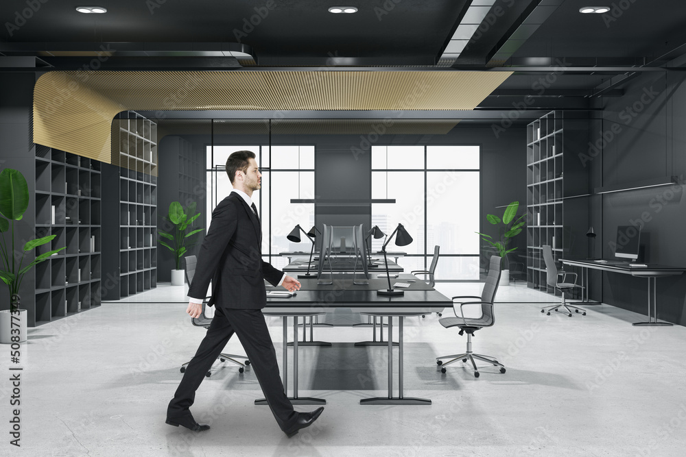 Obraz premium Attractive thoughtful young european business person walking in wooden and concrete office interior with furnituire and window with city view. CEO, executive and consulting concept.