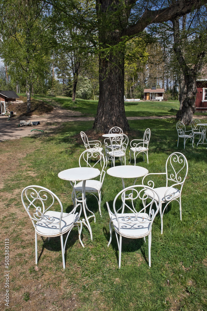 Outdoor restaurant background, metal white chairs and tables
