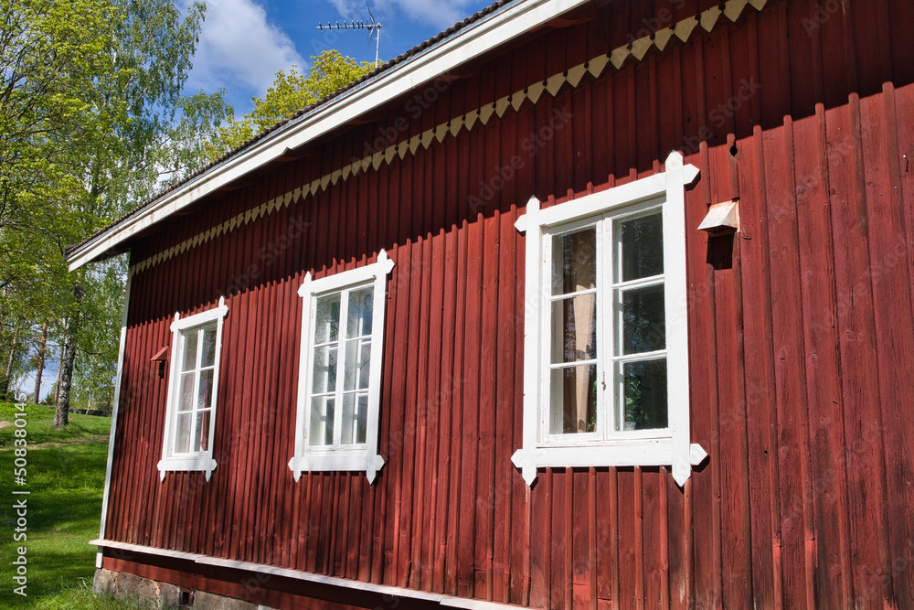 white windows in old red wooden house wall, Finland