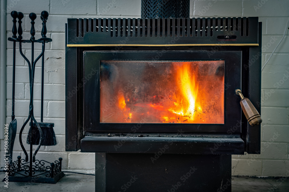 Wood fired fireplace with tools on the side Wood fired fireplace with tools on the side