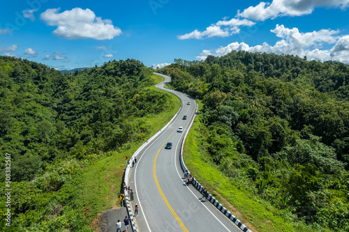 The zigzag road is similar to the number 3. This road is built on a mountain  past the forest in Nan  Thailand  so it will have good scenery  be famous  and have tourists who come to take pictures.