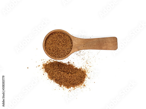 Coconut palm sugar in a wooden spoon isolated on white. brown coconut palm sugar. Coconut palm sugar as a sprinkle for cakes and pies