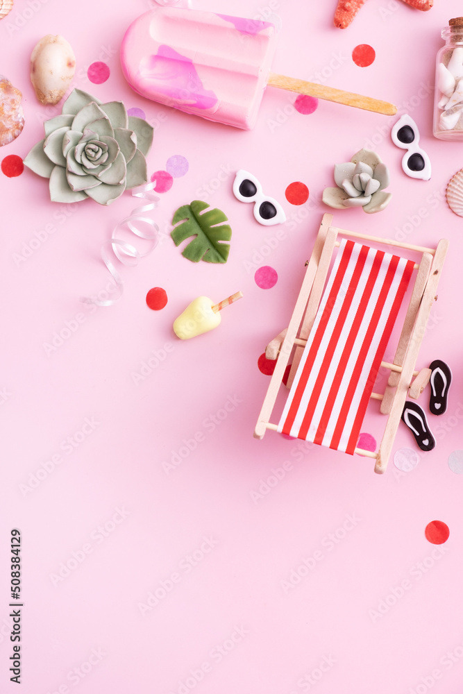 Accessories for beach summer party - longer chairs, umbrellas, ice cream top view. Beach party concept with copy space. Vertical format