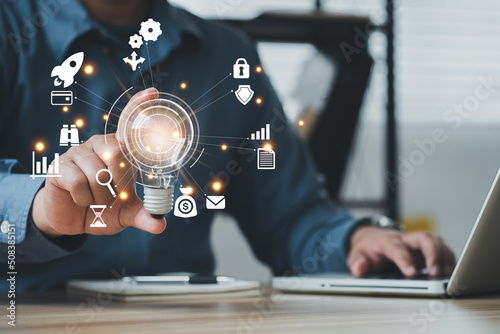 Businessman using a computer to AR virtual screen dashboard with project management with icons of scheduling, budgeting, communication..