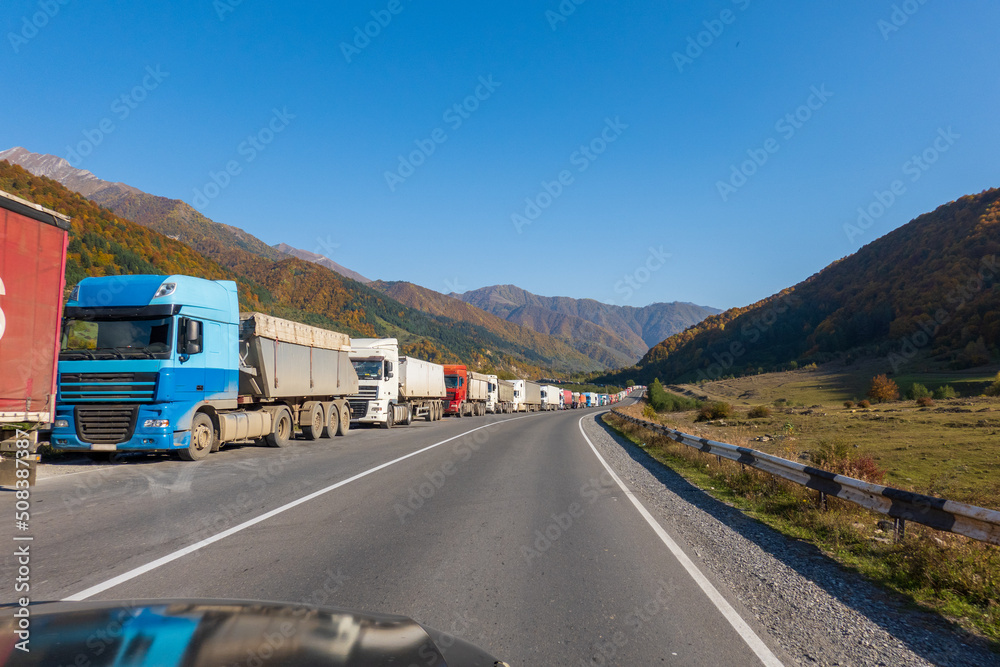 Obraz premium Trucks on roadside near mountains