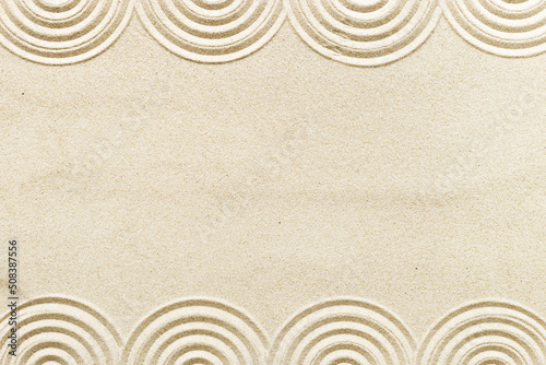 Top view pattern in Japanese Zen Garden with close up concentric circles on sand for meditation and relaxation. Aesthetic minimal sand background with copyspace, beige neutral tones.