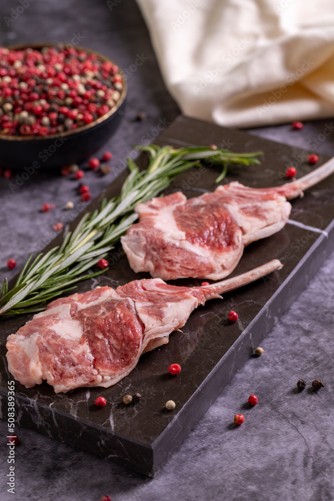 Lamb chops on dark background. Raw lamb chops with spices. close up
