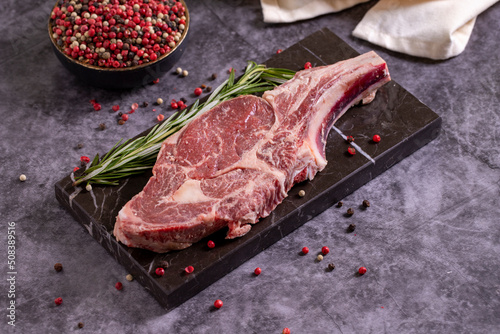Veal chops on dark background. Fresh raw veal chops with spices. close up