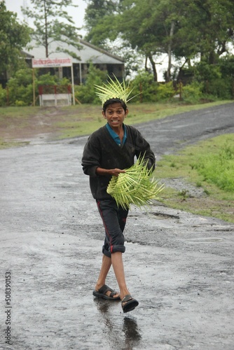 indian boy selling leaf photo