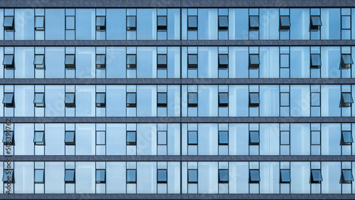 Office windows facede. Blue glass and steel frame,background texture. front view