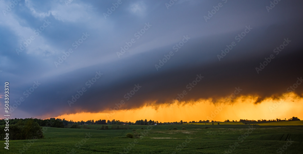Storm cloud in the sunset light, shelf cloud with dramatic light