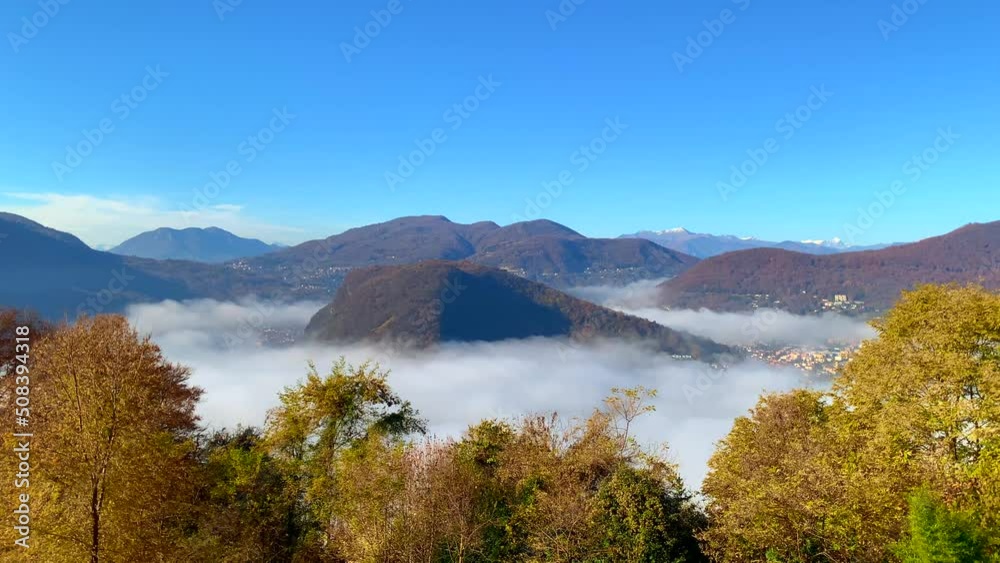 Panoramic View over Alpine Lake Lugano on the Border to Italy with Sea of Clouds and Mountain in a Sunny Autumn Day in Ticino, Switzerland Panoramic View over Alpine Lake Lugano on the Border to Italy with Sea of Clouds and Mountain in a Sunny Autumn Day in Ticino, Switzerland