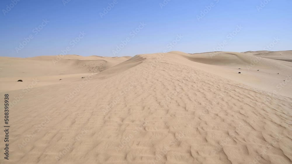 Walking on the top of a dune, desert landscape of the Middle East with blue sky, real time video Walking on the top of a dune, desert landscape of the Middle East with blue sky, real time video