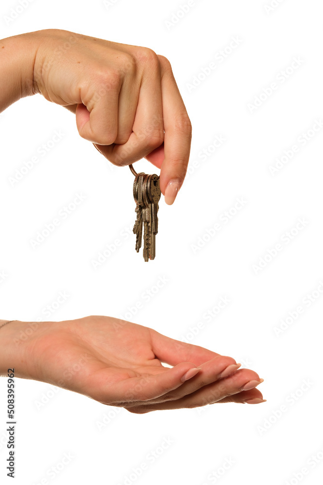 A hand holding keys on a white background A hand holding keys on a white background