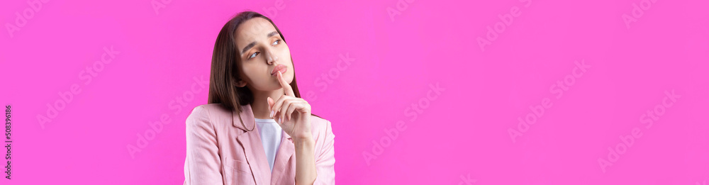 Portrait of beautiful young woman in pink jacket thinking isolated on red background Portrait of beautiful young woman in pink jacket thinking isolated on red background