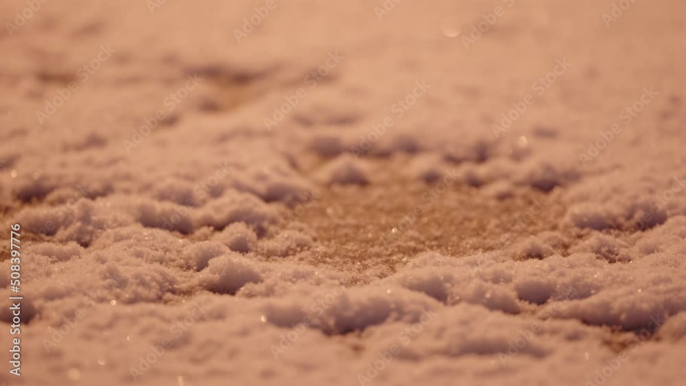 Close up of the snow falling and lie on the ground at snowy night Close up of the snow falling and lie on the ground at snowy night