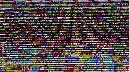 Colorful code background. compressed javascript code on computer screen. Software developer coding screen