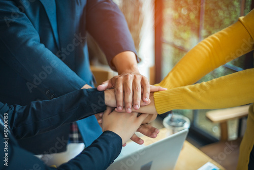 A group of young people hands coordination is a symbol of unity within the organization to strive for the success of the team and the company. The concept of unity within a business.