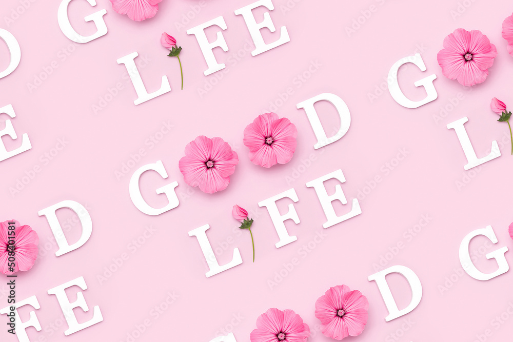Good life. Creative inspirational pattern made with motivational quotes from white letters and beauty natural flowers on pink background Good life. Creative inspirational pattern made with motivational quotes from white letters and beauty natural flowers on pink background