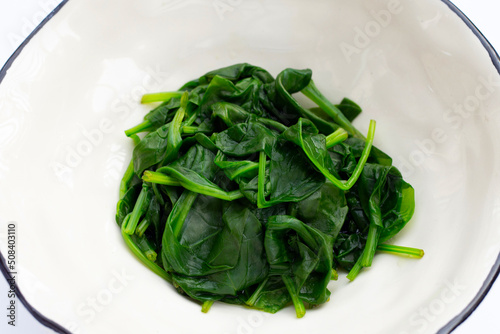 Boiled spinach on white background.