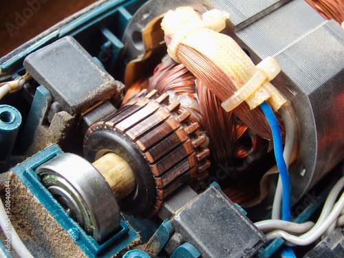 Repair of the brush electric motor. The device of the collector brush assembly of the electric motor. Rotor, collector, brushes close up.