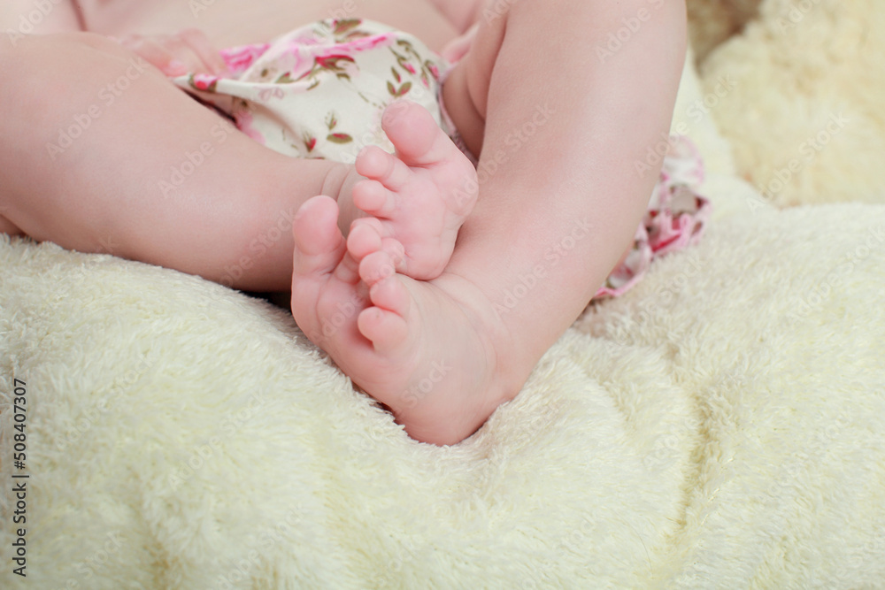 newborn child. baby legs. the legs of the newborn. legs on green background. child's feet newborn child. baby legs. the legs of the newborn. legs on green background. child's feet