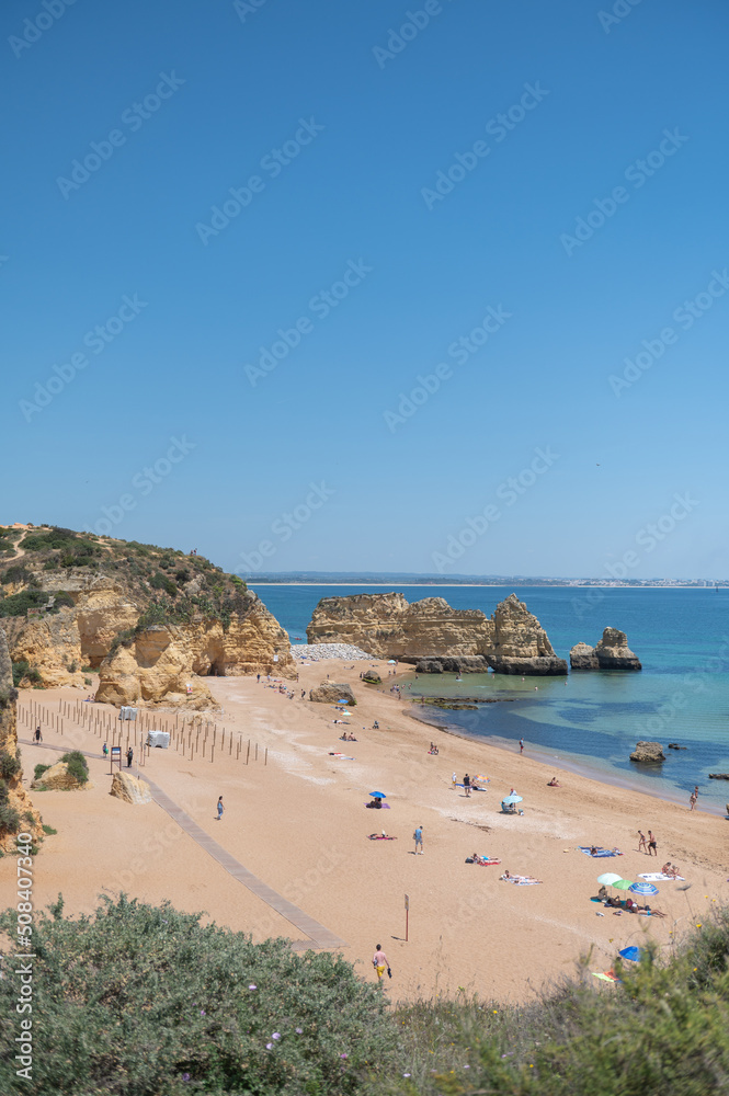 Panorama of the tourist Praia de Dona Ana de Lagos in the Algarve, Portugal in the summer of 2022.