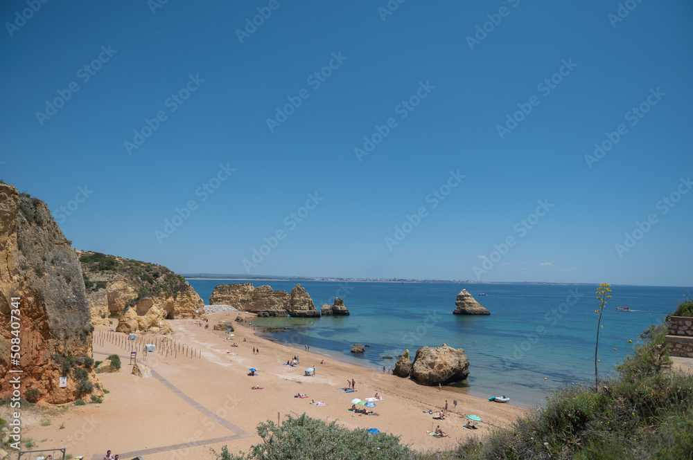Obraz premium Panorama of the tourist Praia de Dona Ana de Lagos in the Algarve, Portugal in the summer of 2022.