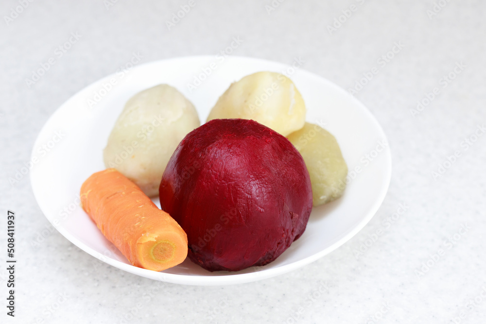 boiled vegetables on a plate. boiled beets, boiled potatoes, boiled carrots for salad boiled vegetables on a plate. boiled beets, boiled potatoes, boiled carrots for salad