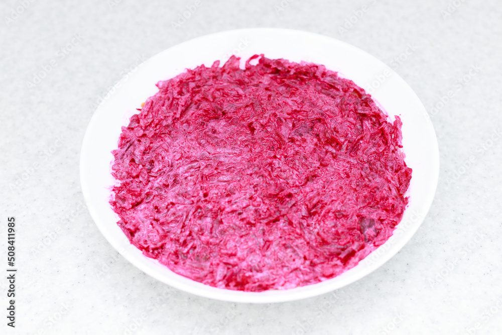 salad with beets in a white plate on the table. menu. pubie salad salad with beets in a white plate on the table. menu. pubie salad