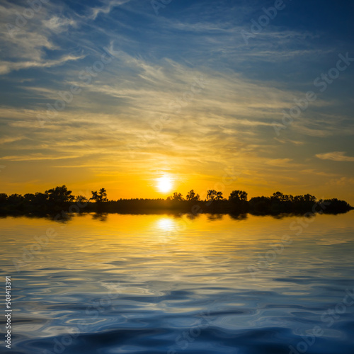 dramatic sunset reflected in water, beautiful summer natural background