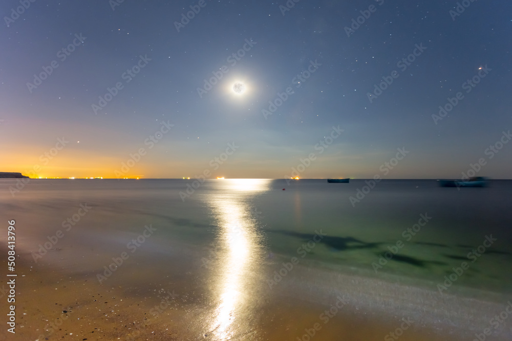 full moon shining above quiet sea bay, night summer sea vacation scene