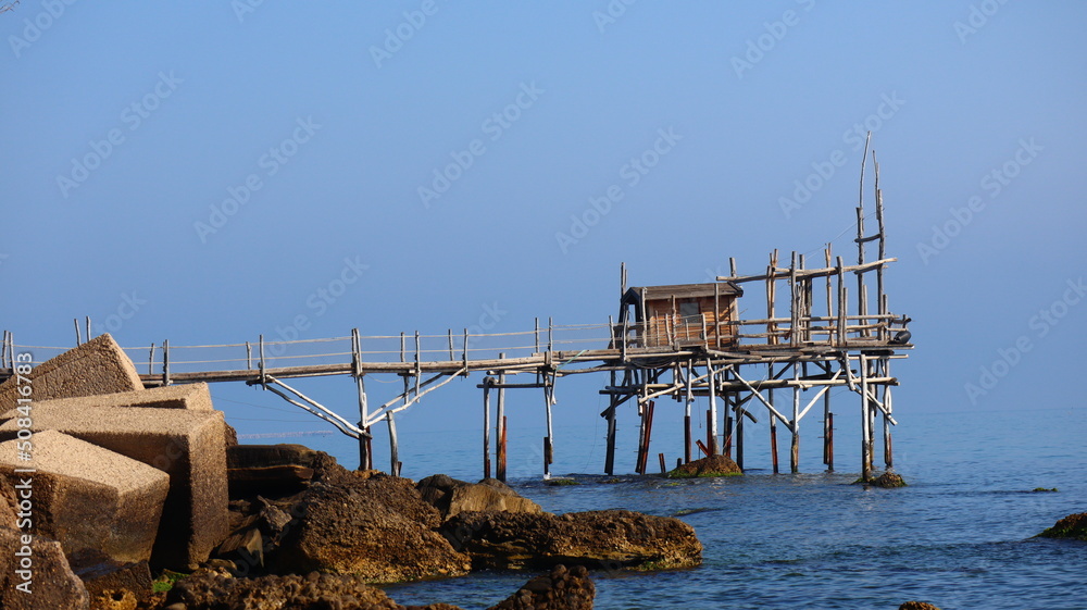 Coast of the Trabocchi, Trabocco in Marina di San Vito Chietino. The Trabocco is a traditional wooden fishing house on pilework typical of Adriatic sea, coast of Abruzzo, Italy Coast of the Trabocchi, Trabocco in Marina di San Vito Chietino. The Trabocco is a traditional wooden fishing house on pilework typical of Adriatic sea, coast of Abruzzo, Italy