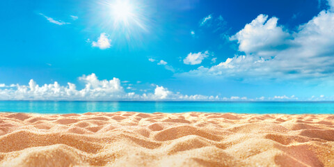 Abstract blur defocused background. Tropical summer beach with golden sand, turquoise ocean and blue sky with white clouds on bright sunny day. Colorful landscape for summer holidays.