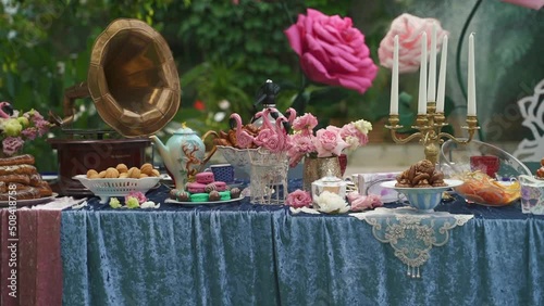 Decor in the style of Alice in Wonderland.Festive table decoration wedding banquet.Interior of a wedding hall decoration ready for guests.Beautiful room for ceremonies and weddings.Wedding concept. 