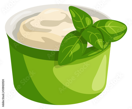 White dip sauce with green leaves aside. Tasty condiment