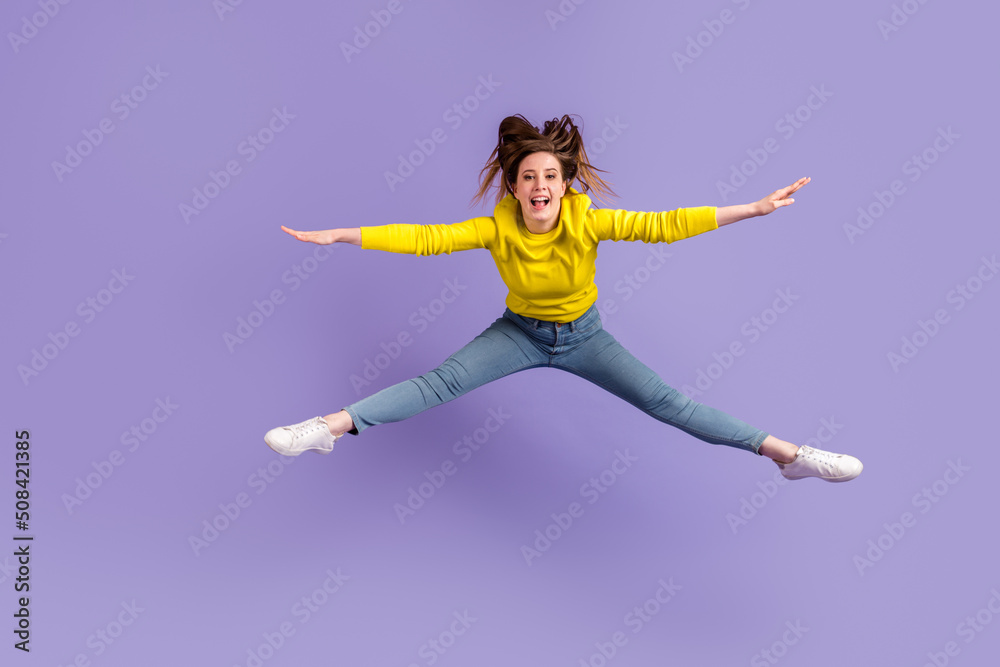 Obraz premium Full length photo of young girl have fun jump up sportive wear modern outfit isolated over purple color background