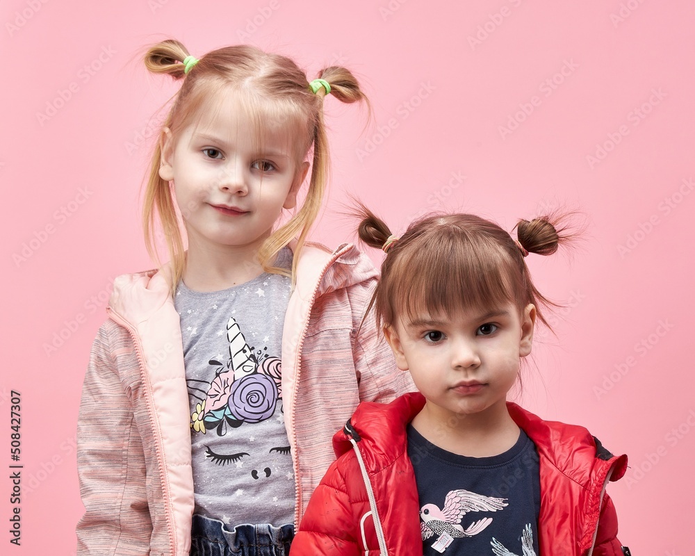 sister's children in a jacket on a pink background. sister's children in a jacket on a pink background.