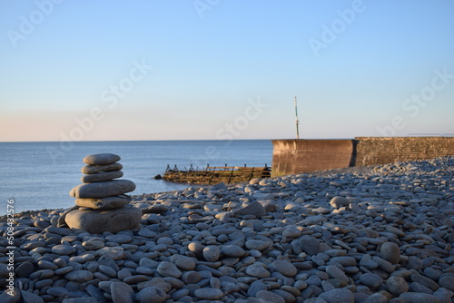 Pebble stack at Aberaeron beach and harbour, Wales, UK. photo