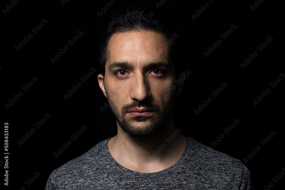 Crying man on a black background. Man showing emotion Crying man on a black background. Man showing emotion