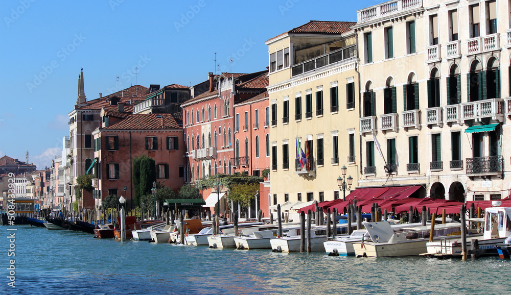Beautiful city view of Venice Canals, Streets and Monuments. Colorful buildings near water. Sunny day in Italy. Tourist destinations concept. 