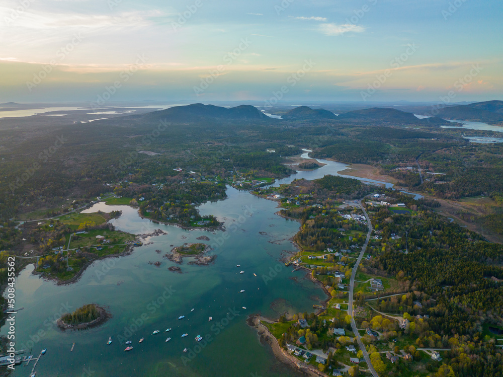 Bass Harbor and village aerial view at sunset with Mountains in Acadia National Park at the background in town of Tremont on Mt Desert Island, Maine ME, USA. 