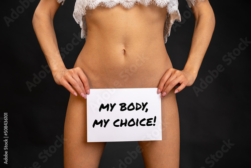 young woman holds a my-body-my-choice-sign
